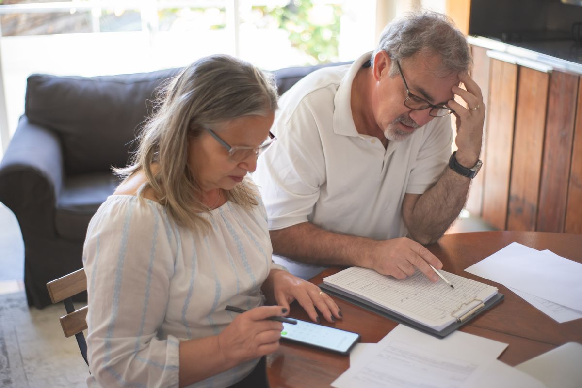 Elderly couple reviewing their plans together at home